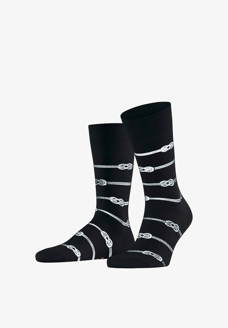 Chaussettes noires montantes avec un motif de corde blanche et de nœuds espacés uniformément sur le tissu.