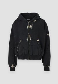 Black zip-up hoodie with distressed details, featuring a hood, large front pockets, and a textured pattern with light-colored spots.