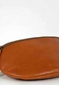 Brown leather clutch bag with a rounded shape, zip closure, and smooth texture; features subtle stitching and no visible patterns.