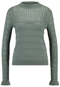 Pletený zelený svetr s texturovaným vzorem, s vysokým výstřihem a dlouhými rukávy. Ozdoben složitými švy.