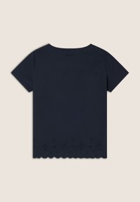 T-shirt in cotone navy a maniche corte, con orlo scallop e motivi floreali tagliati al laser lungo il bordo inferiore.