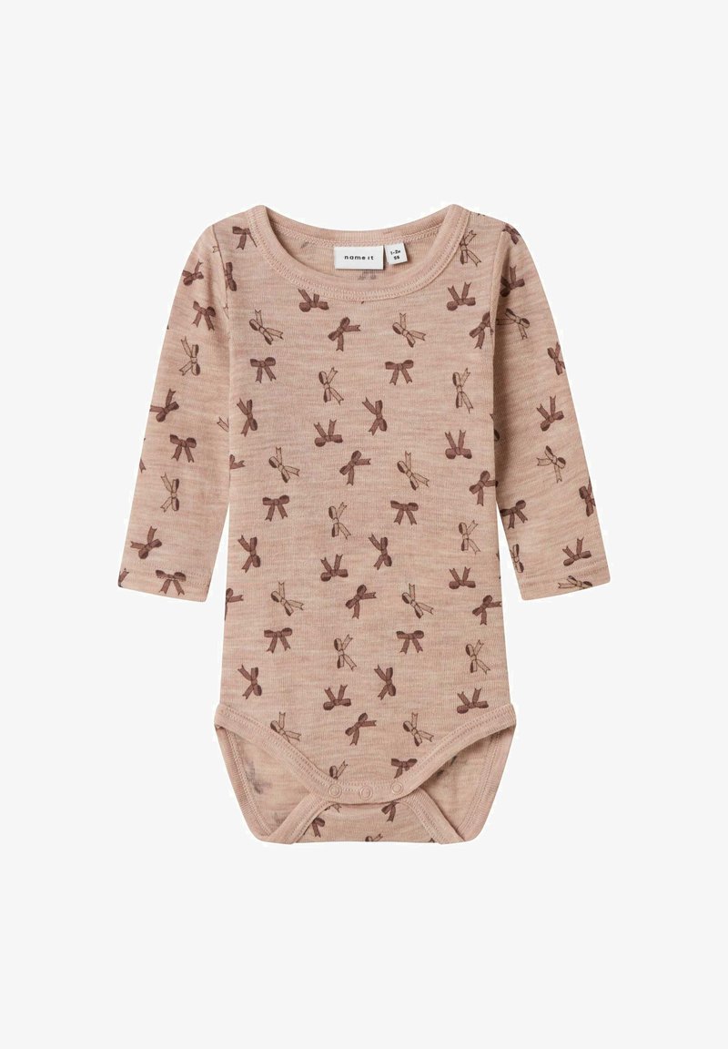 Long-sleeve baby bodysuit in soft beige fabric with a muted brown bow print. Features snap closures at the bottom for easy dressing.