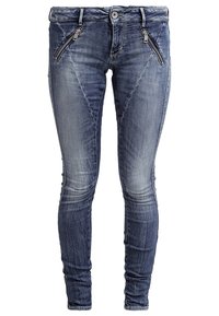 Jean skinny en denim bleu foncé avec une finition délavée. Dispose de deux poches zippées à l'avant et d'une coupe ajustée tout au long.