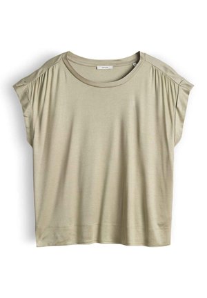 T-shirt beige a maniche corte dalla vestibilità ampia con scollo rotondo e leggero raccoglimento sulle spalle, distesa su uno sfondo bianco.
