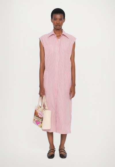 Red and white striped shirt dress with a collared neckline and short sleeves, paired with a light pink tote bag. Black flat shoes.