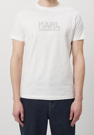 Witte katoenen t-shirt met een metallic zilveren "KARL LAGERFELD" logo op de voorkant, korte mouwen en een ronde hals.