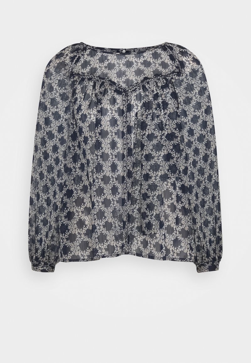 Blouse bleu marine transparente avec motif floral blanc en cercle, manches longues bouffantes, empiècement froncé et col rond.