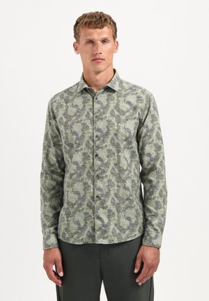 Green patterned long-sleeve shirt featuring a button-down collar, textured fabric, and dark-toned leaf shapes throughout the design.