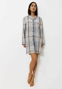 Plaid košilové šaty v světle šedé a béžové barvě s dlouhými rukávy, knoflíky vpředu a černými akcenty. Měkký materiál s uvolněným střihem.