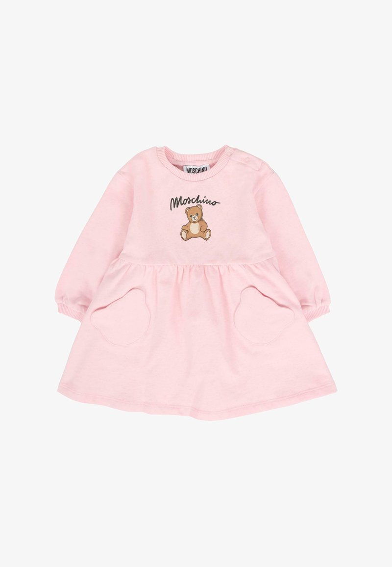 Robe rose à manches longues, col rond, présentant un graphisme de ours en peluche et deux poches circulaires. Fabriquée en tissu doux.