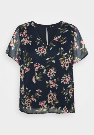 Laivastonsininen kukkakuosinen pusero, jossa on lyhyet läpikuultavat hihat, v-pääntie ja avonainen takadetalji. Kuvioissa on punaisia ja vaaleanpunaisia kukkia sekä vihreitä lehtiä. Kevyt kangas.