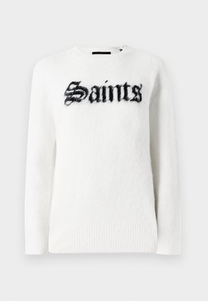 Valge pluus pehmest kangast, millel on esiosas must "Saints" graafika. Ümar kaelus, pikad varrukad ja soonikkoes äärised.