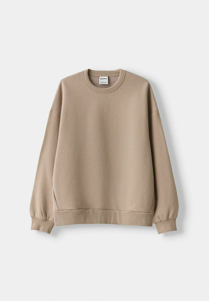 Felpa oversize marrone chiaro con collo a giro, maniche lunghe, polsini a costine e orlo ampio, realizzata in tessuto morbido.