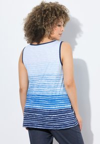 Canotta senza maniche blu sfumata caratterizzata da un motivo a strisce orizzontali, che va dal blu chiaro al blu scuro, con scollatura arrotondata e rifiniture in blu navy.