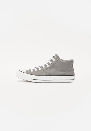 Gray high-top sneaker made of canvas with white laces, rubber toe cap, and black-striped sole. Features a textured upper and soft collar.