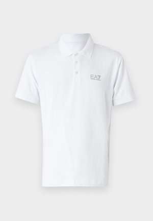 White polo shirt made of cotton. Features a classic collar, three-button placket, and light gray EA7 logo on the chest. Short sleeves.