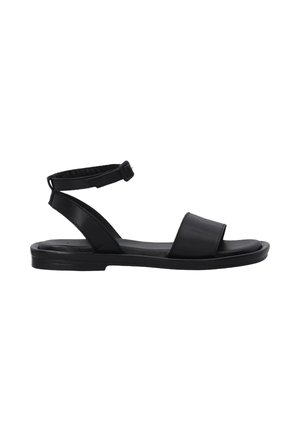Black leather sandal with an adjustable ankle strap, flat sole, wide toe band, and minimalist design. Smooth texture and sleek appearance.