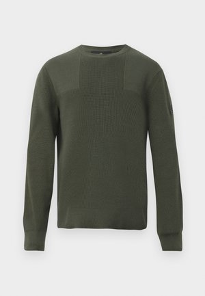 Olive green knit sweater with a round neckline, long sleeves, textured fabric, and panel detailing on the front. Features a small logo on the sleeve.