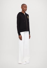 Versace Jeans Couture Športna jopa s kapuco na zadrgo - black/gold