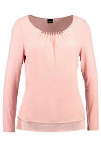 Różowa bluzka z długimi rękawami i okrągłym dekoltem, z marszczonym materiałem na klatce piersiowej oraz przezroczystą warstwą wszytą na dole. Gładki, elastyczny materiał.