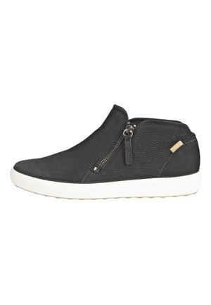 Black leather ankle boots featuring a side zipper, textured surface, and a white rubber sole for grip. Minimalistic design with subtle branding.