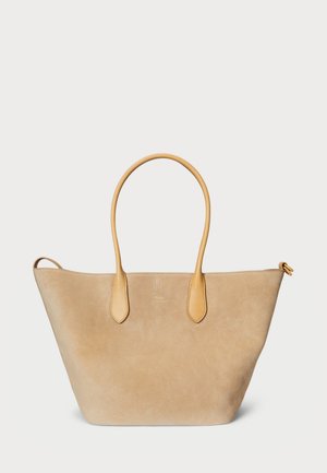 Beige suede tote bag with smooth leather accents, double handles, and a wide opening. Minimalistic design with no visible patterns.