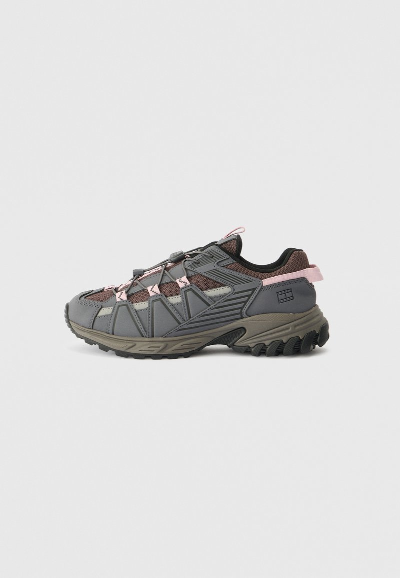 Gray and taupe hiking shoes with pink accents, featuring a textured upper, reinforced toe, and a rugged sole for traction.