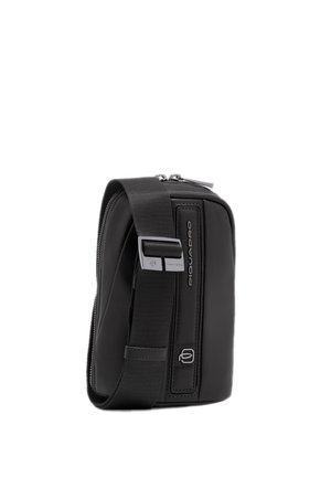 Compact black crossbody bag with adjustable wide strap, silver buckle, zipper closure, and "Piquadro" branding on the front panel.