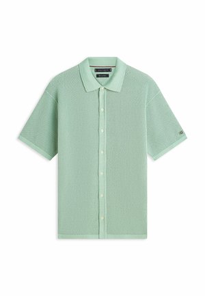 Jasnozielona, krótka koszulka polo z dzianiny z przodem na guziki i teksturowanym wzorem siateczki, z klasycznym kołnierzykiem.