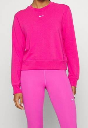 Fuchsia Nike sweatshirt with long sleeves and crew neckline. Features a small white logo on the chest, paired with matching pink leggings.