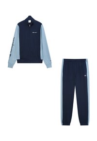 Chándal en tonos azul marino y claro: chaqueta con cremallera y mangas largas con logo, combinada con pantalones ajustados a juego que presentan una cinturilla elástica y rayas laterales.