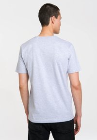 Gray short-sleeve T-shirt, crew neck, casual fit, made of soft cotton blend fabric. Textured finish, no visible patterns or logos.