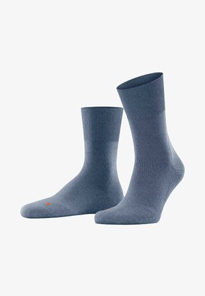 Blue cotton socks with a ribbed cuff, smooth texture, and a red accent dot near the toe. Ankle height with a fitted shape.
