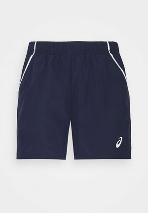 Granatowe spodenki sportowe z elastyczną talią, białym przeszyciem po bokach i małym białym logo na dolnej części prawej nogawki.