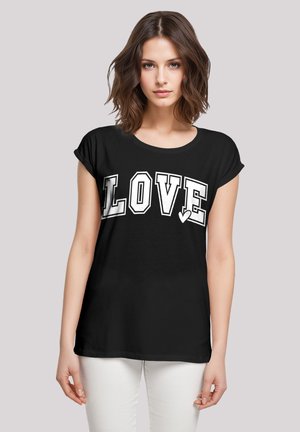 Black short-sleeve t-shirt featuring a large white "LOVE" print in an outlined font, with a heart accent on the letter 'V'.