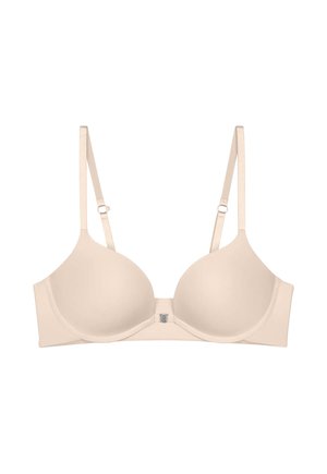 Beigevärinen toppaamaton rintaliivi, jossa on kaarituki, säädettävät olkaimet ja etuklipsi valkoisella taustalla.