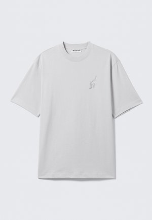 Light gray short-sleeve T-shirt with crew neck and small black line drawing of a stretching cat on the left chest.