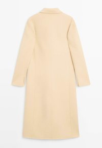 Hellbeiger Mantel mit Reverskragen, langen Ärmeln und geradem Schnitt. Verfügt über seitliche Schlitze und eine saubere Nahtführung. Glattes Wollmischgewebe.