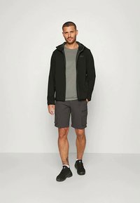 Black zip-up jacket over a gray t-shirt, paired with gray cargo shorts and black sneakers. The fabric appears smooth and casual.