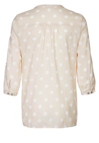 Camicia beige chiaro con pois bianchi, maniche lunghe con polsini abbottonati e design posteriore plissettato. Tessuto con texture liscia.