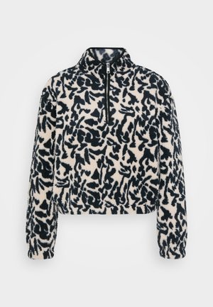 Cropped fleece pullover with a black and cream abstract pattern, high collar, and front half-zip closure. Soft, textured fabric.