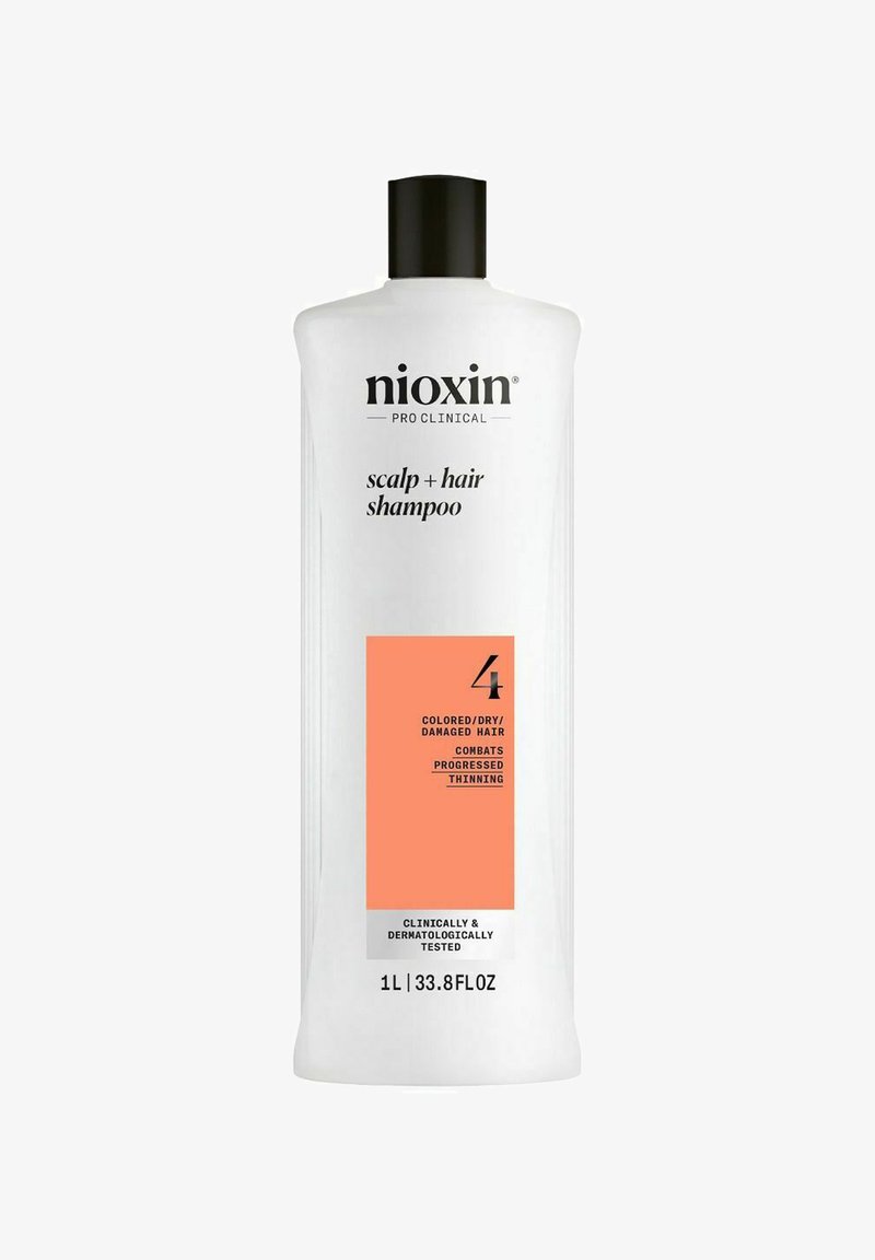 White plastic bottle of Nioxin Pro Clinical Scalp + Hair Shampoo, 1L, with black cap and orange label detailing hair care for colored, dry, damaged hair.
