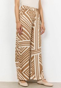 Brown and cream patterned wide-leg pants with an elastic waistband, featuring bold geometric stripes, smooth texture, and flowy fabric.
