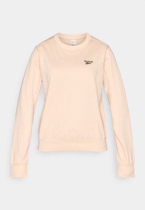Sudadera de algodón beige con mangas largas, escote redondo, puños y dobladillo acanalados, con un pequeño logo negro de Reebok en el pecho.