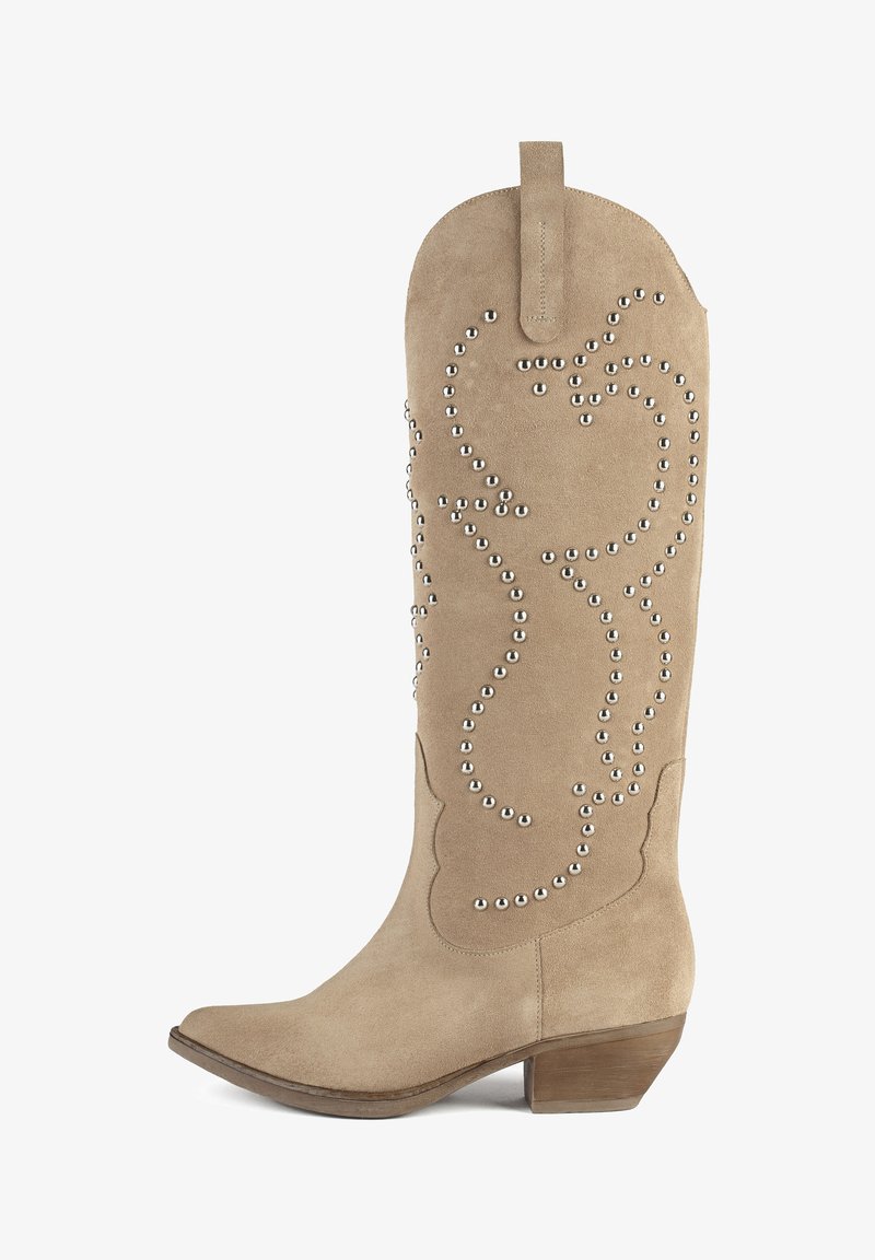 Tan suede knee-high boots with a pointed toe and a stacked heel, featuring decorative silver studs in a swirl pattern along the shaft.