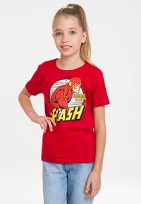 Red cotton t-shirt featuring a graphic of The Flash, with yellow text and black outlines. Short sleeves and a classic crew neck design.
