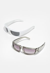 Two pairs of sunglasses: one white with dark lenses and one gray with gradient purple lenses. Both have a sleek, angular design.