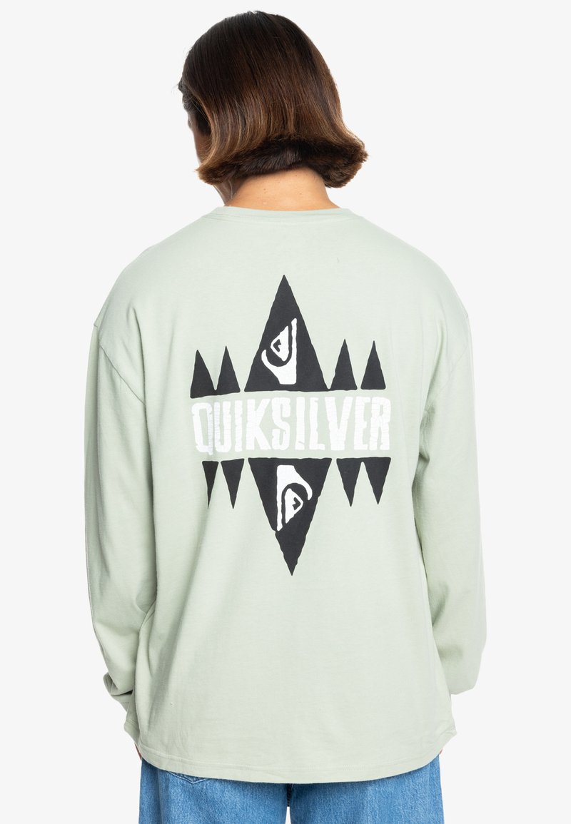 Light green long-sleeve shirt with a large black and white geometric graphic on the back, featuring the word "QUIKSILVER." Soft cotton material.