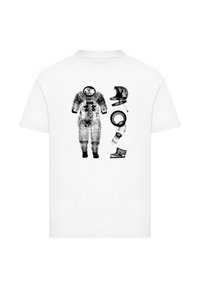 White T-shirt featuring black graphic prints of an astronaut suit, helmet, boot, and accessories, illustrating a space theme.