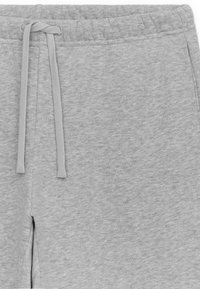 Gray sweatpants with a soft texture, elastic waistband, and matching drawstring. Details include a simple design without pockets.